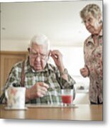 Senior Man Inserting His Hearing Aid Metal Print