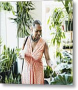 Senior Woman Touching Plant Leaf While Shopping In Plant Store Metal Print