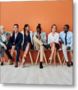 Shot Of A Group Of Businesspeople Sitting Against An Orange Background Metal Print