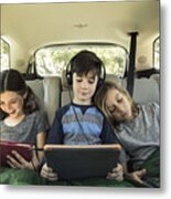 Siblings Using Digital Tablet In Back Seat Of Car On Road Trip Metal Print