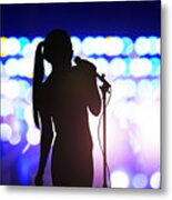 Silhouette of woman with microphone singing on concert stage in front of crowd Metal Print