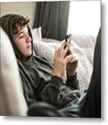 Teenage Boy Using Smartphone At Home Metal Print