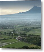 The Prambanan Temple With The Merapi Volcano In The Background Metal Print