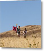 Two Children Run Through A Golden Field With A Kite Metal Print