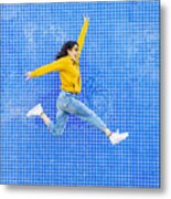Woman Jumping In Front Of A Blue Background Metal Print