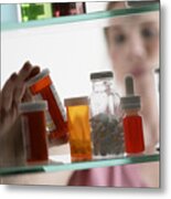 Woman Taking Pills From Medicine Cabinet Metal Print
