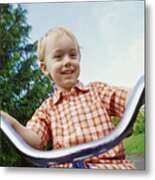 Young Blond Boy Riding A Tricycle In A Park Metal Print