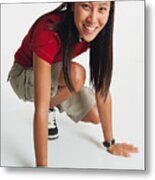Young Woman With Long Hair Wears Red T-shirt And Shorts Crouches Her Hands On Floor Smiles To Camera Metal Print
