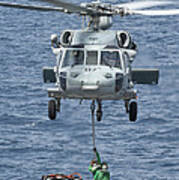 A Mh-60s Sea Hawk Helicopter Lifts Poster