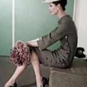 A Model Sitting Down With A Bouquet Of Flowers Poster