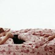A Model Sleeping On Floral Bed Linens Poster