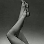 A Model's Legs Wearing Sandals Poster