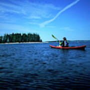 A Woman Paddles Her Sea Kayak Poster