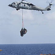 An Mh-60s Sea Hawk Picks Up Cargo Poster
