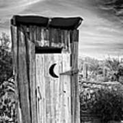 Desert Outhouse Under Stormy Skies Poster
