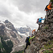 Four Mountaineers Ascend Cliff Above Poster