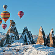 Hot Air Balloons Over Snow Covered Rock Poster