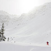 Skier Climbs Snowy Ridge Below Misty Poster