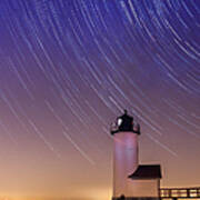 Stars Trailing Over Lighthouse Poster