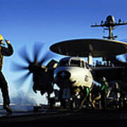 An Airman Guides An E-2c Hawkeye Poster