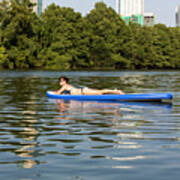 A Female Stand Up Paddle Board Lounges On The Crystal Clear Blue Waters Of On Lady Bird Lake In Austin, Texas- Stock Image Poster