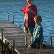 Boys On A Wooden Boat Dock In Late Afternoon Poster