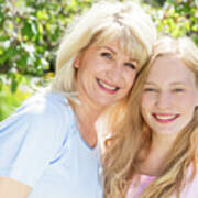 Mother And Daughter Spending Time Together In A Summer Garden. Poster