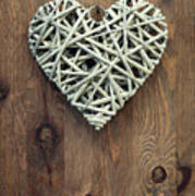 Reed Heart Hanging Against A Rustic Wooden Background. Poster