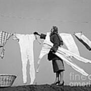 Woman Removing Frozen Clothes Poster