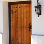Wooden Door In Stucco Wall With Ornate Outside Lamp Poster