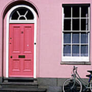 Bicycle Leaning Against Pink House Poster