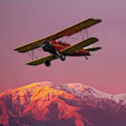 Biplane Over Snowcapped Mountains Poster