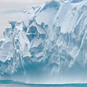 Blue Iceberg Carved By Waves Floats In Poster