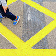Child's Legs On Yellow Lines On Asphalt. Poster