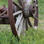 Closeup Vintage Wooden Wagon Wheel In Grass Poster