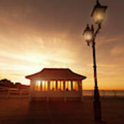 Cromer Pier In Norfolk England Shelter At Sunset Poster