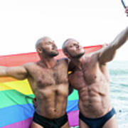 Lgbt Pride Concept. Gay Bear Couple Holding Rainbow Flag With Open Arms Taking A Selfie Photo. Poster