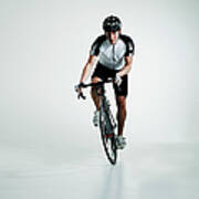 Male Cyclist Standing In Pedals Riding Poster