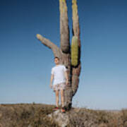 Man Standing Against A Huge Cactus Poster