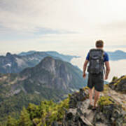 Rear View Of Carefree Hiker With Backpack Walking On Mountain Against Sky Poster