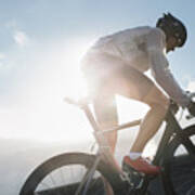 Silhouette Of Cyclist Riding Up In High Poster