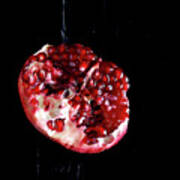 Sliced Pomegranate In Front Of Black Poster