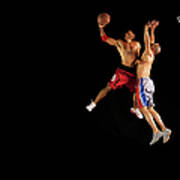 Two Male Basketball Players Jumping Mid Poster