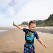 Young Boy Running Kite Along The Beach With Determination. Poster