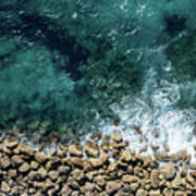 Aerial View From Flying Drone Of Crystal Blue Ocean Water And Sea Wall. Poster