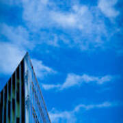 Futuristic Triangular Building Against A Clear Blue Sky Poster