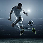 Soccer Player Kicking Ball In Stadium Art Print