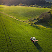 A Farmer Tills A Field With His Tractor Art Print