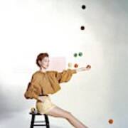 A Model Sitting On A Stool Juggling Art Print