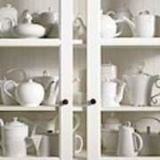 Assorted Tea And Coffee Pots In A Glass Cupboard Art Print